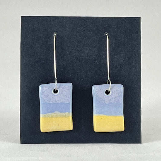 A pair of hand formed porcelain pendant earrings in delicate blue and yellow