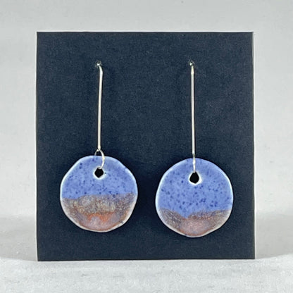 A pair of hand formed porcelain earrings in blue with mauve and orange flecks