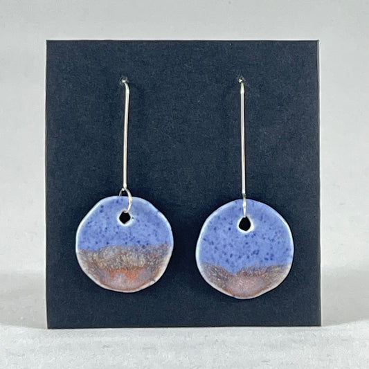 A pair of hand formed porcelain earrings in blue with mauve and orange flecks