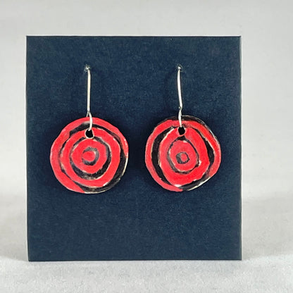 A pair of hand formed porcelain pendant earrings in striking black and red abstract flower pattern
