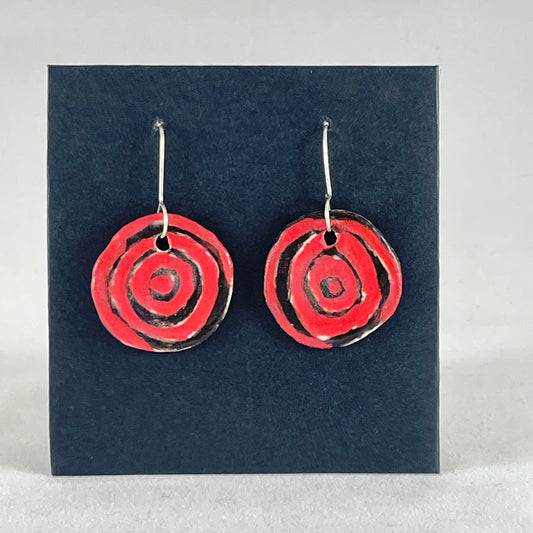 A pair of hand formed porcelain pendant earrings in striking black and red abstract flower pattern
