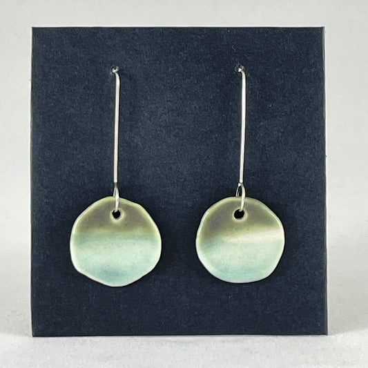 Pair of circular mint and green porcelain earrings. On long sterling silver earring hooks.