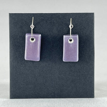 A pair of rectangular shaped porcelain hoop earrings in purple. On sterling silver earrings hooks.