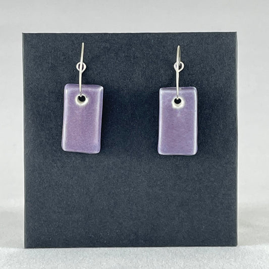 A pair of rectangular shaped porcelain hoop earrings in purple. On sterling silver earrings hooks.