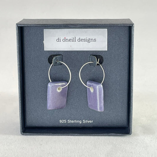 A pair of rectangular shaped porcelain hoop earrings in purple. On sterling silver earrings hooks.