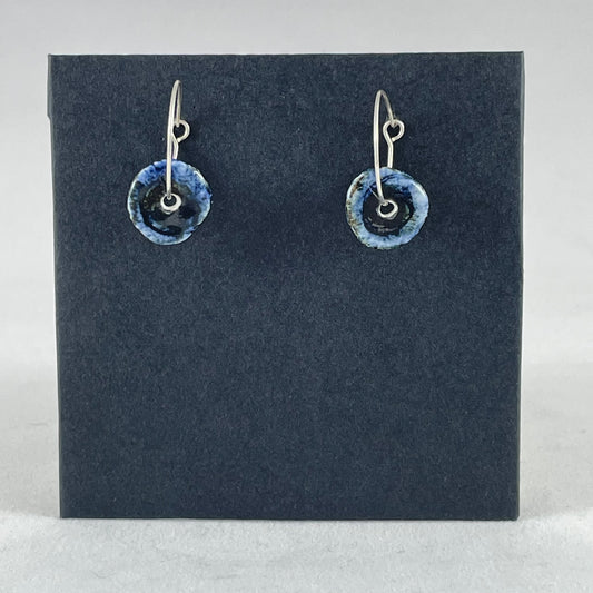 A pair of blue hand coiled porcelain earrings on sterling silver hoops.