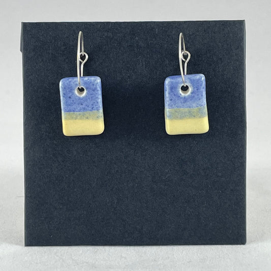 A pair of porcelain earrings in yellow and blue. Cute rectangular pendant on sterling silver hooks.