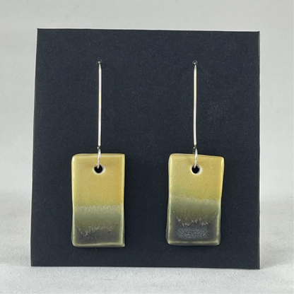 Pair of hand formed porcelain pendant earrings. Yellow and warm green bands of colour on rectangle shape. Sterling silver hooks