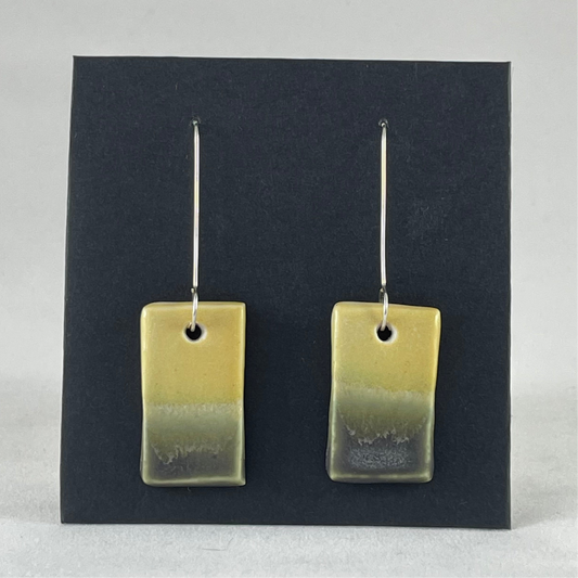 Pair of hand formed porcelain pendant earrings. Yellow and warm green bands of colour on rectangle shape. Sterling silver hooks