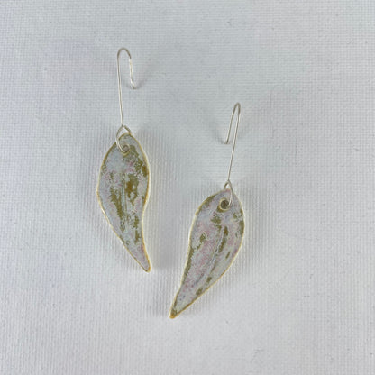 A pair of porcelain earrings in organic gum leaf shape. Photographed on a white background.