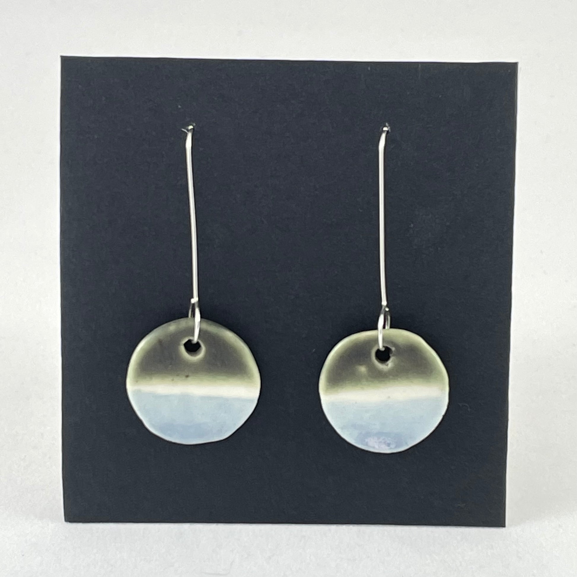 Pair of circular porcelain earrings with  bands of colour: dark green, white and pale blue. On long sterling silver earring hooks.