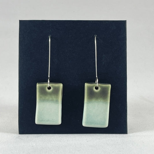 A pair of rectangular shaped porcelain earrings in mint and green. On sterling silver earrings hooks.