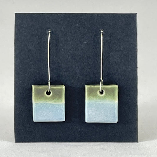 A pair of square shaped porcelain earrings in blue and green. On sterling silver earrings hooks.