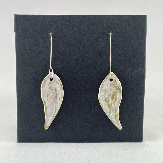 A pair of porcelain earrings in organic gum leaf shape. Photographed on a black background.